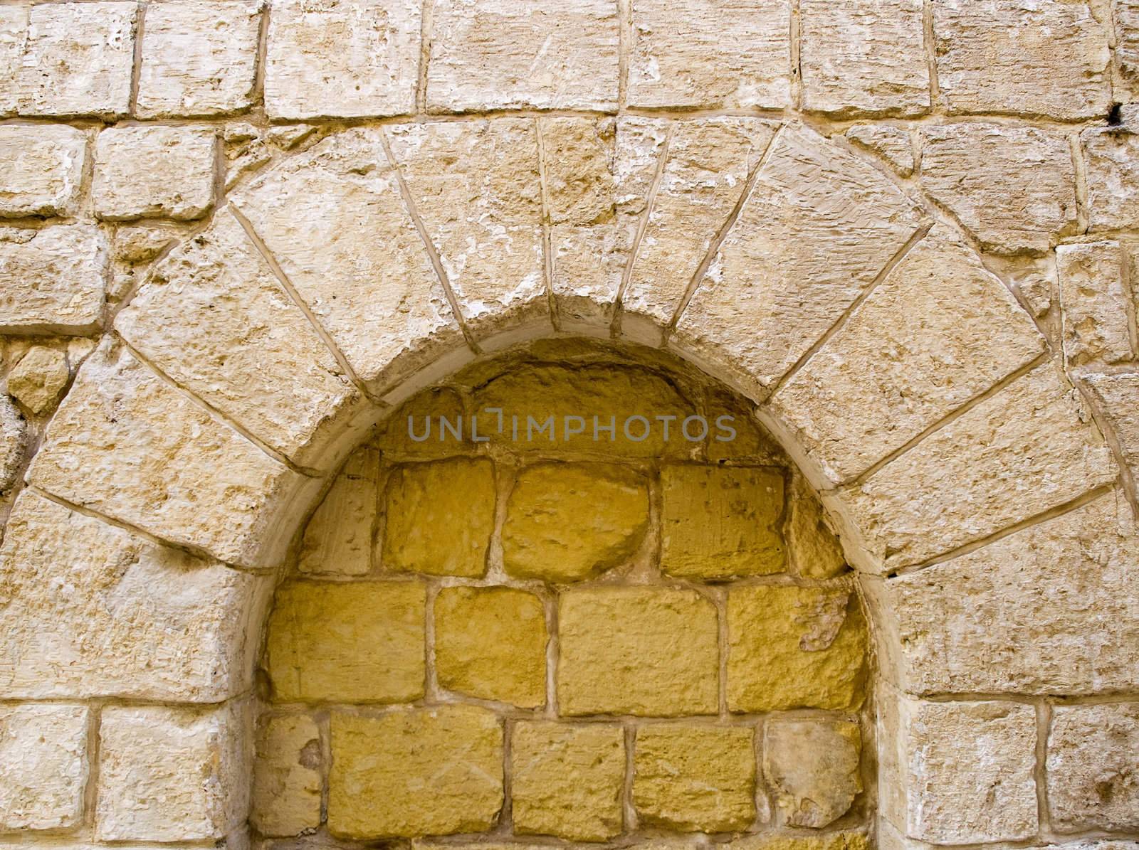Detail and texture of a closed up Norman medieval arch in Malta