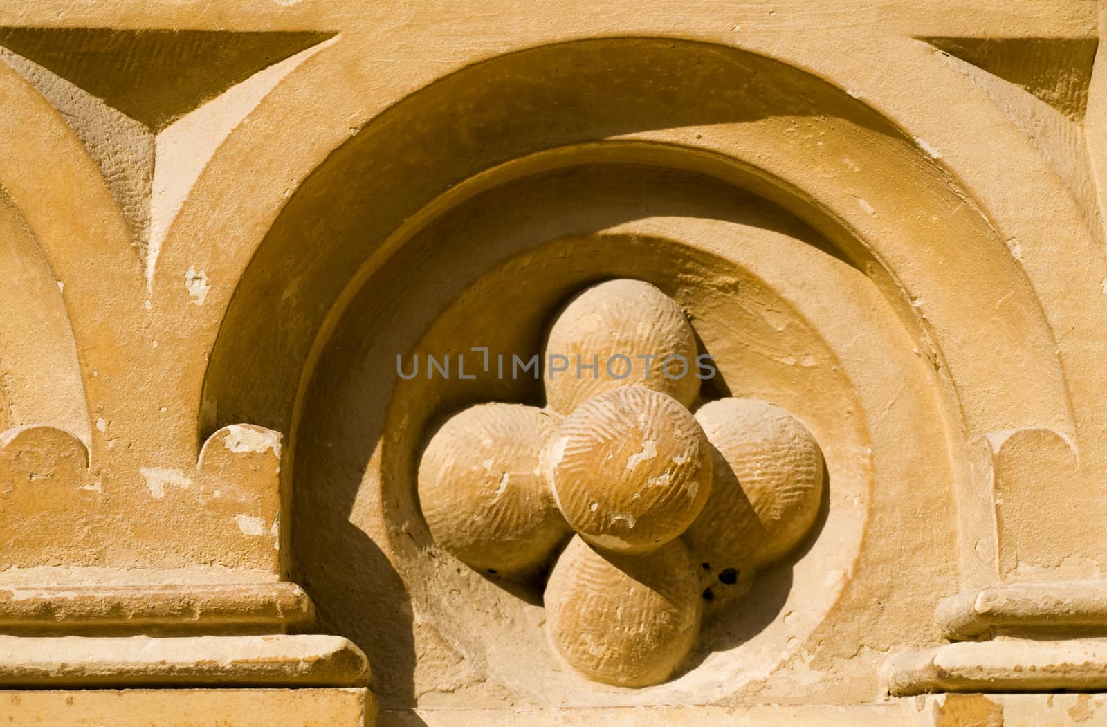 Detail of medieval limestone facade in traditional Gothic style in Mdina on the island of Malta