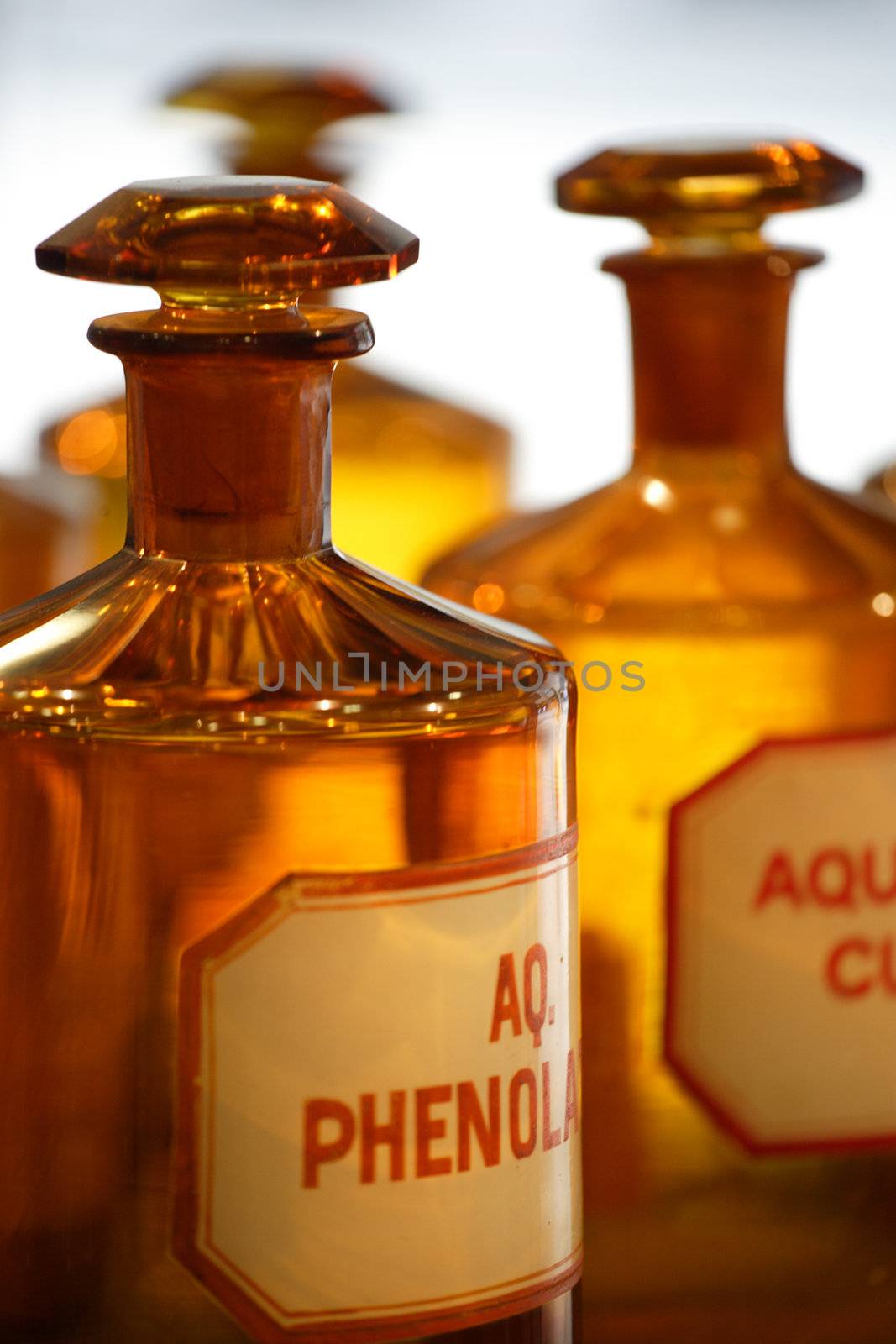 An image of vintage chemical bottles in a pharmacy.
