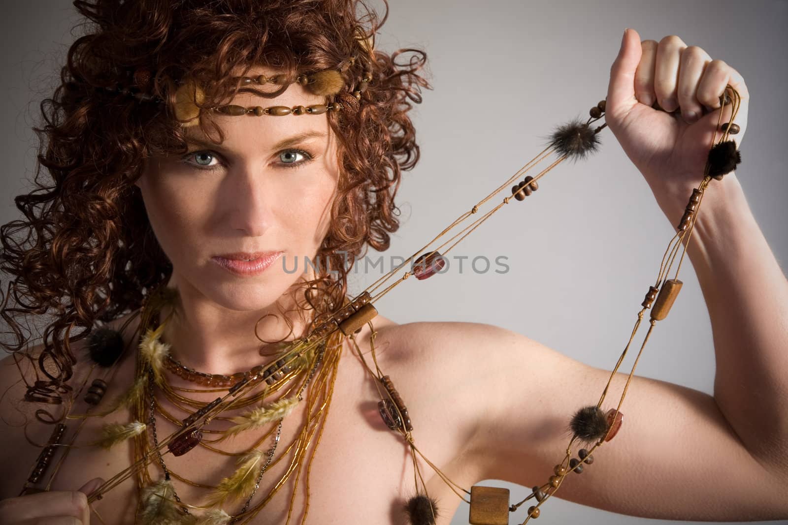 Beautiful woman with a wild look on grey background