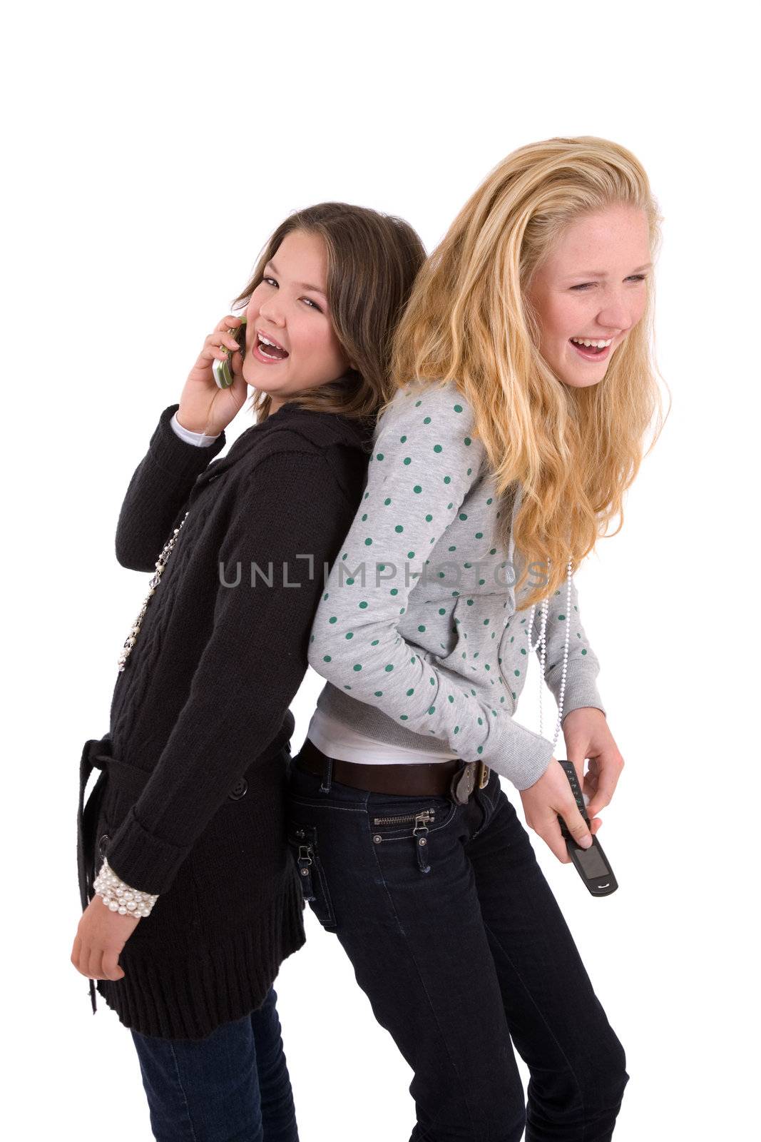 Two teenage girls having a laugh while on their phone