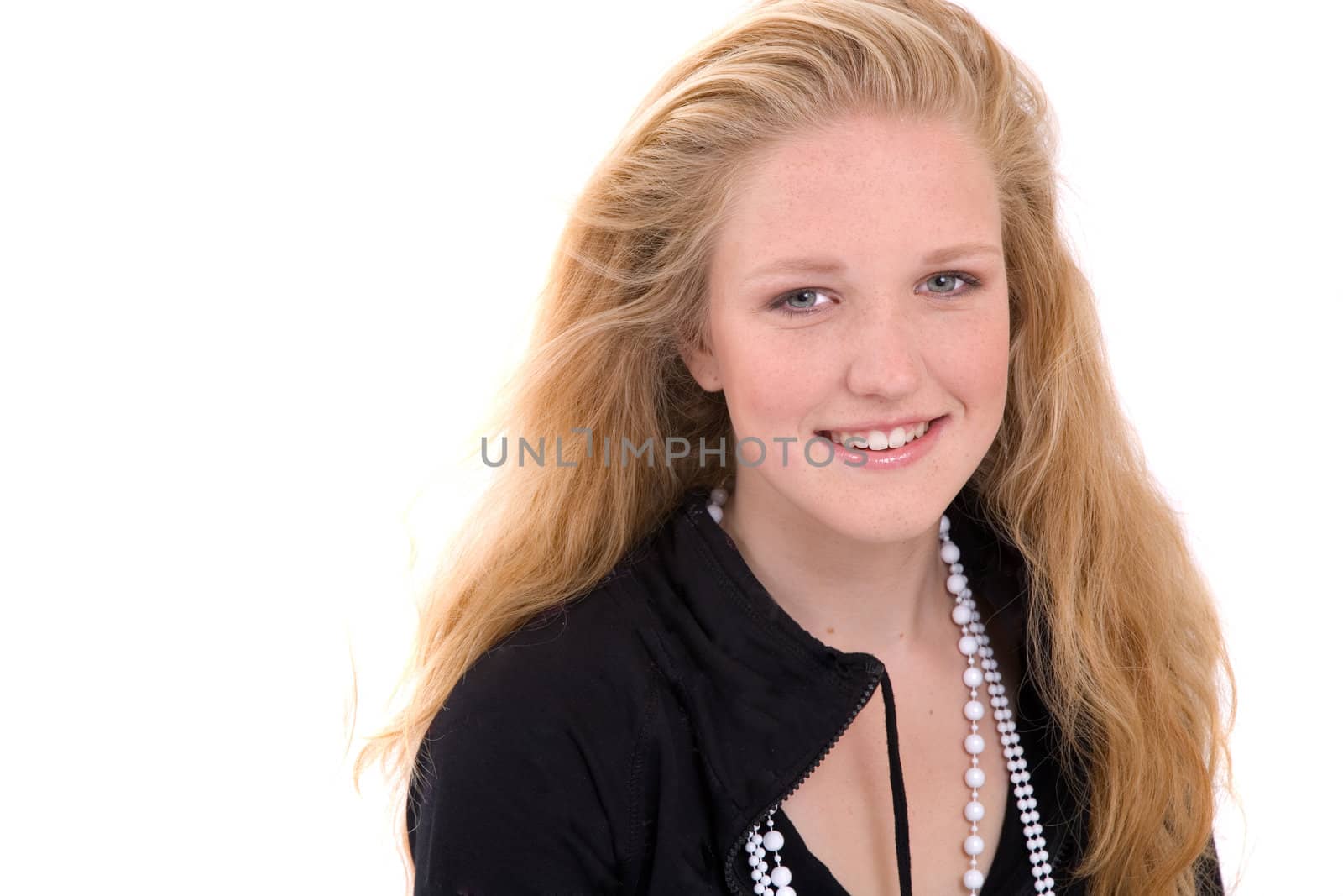 Pretty blond teenage girl smiling on white background