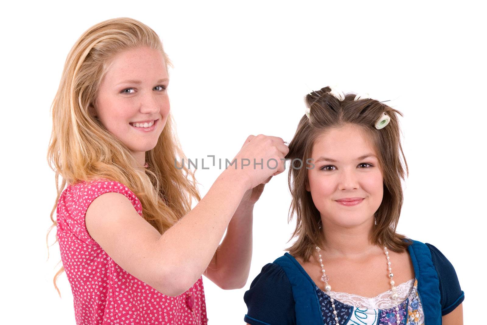 Two teenage friends doing each others hair