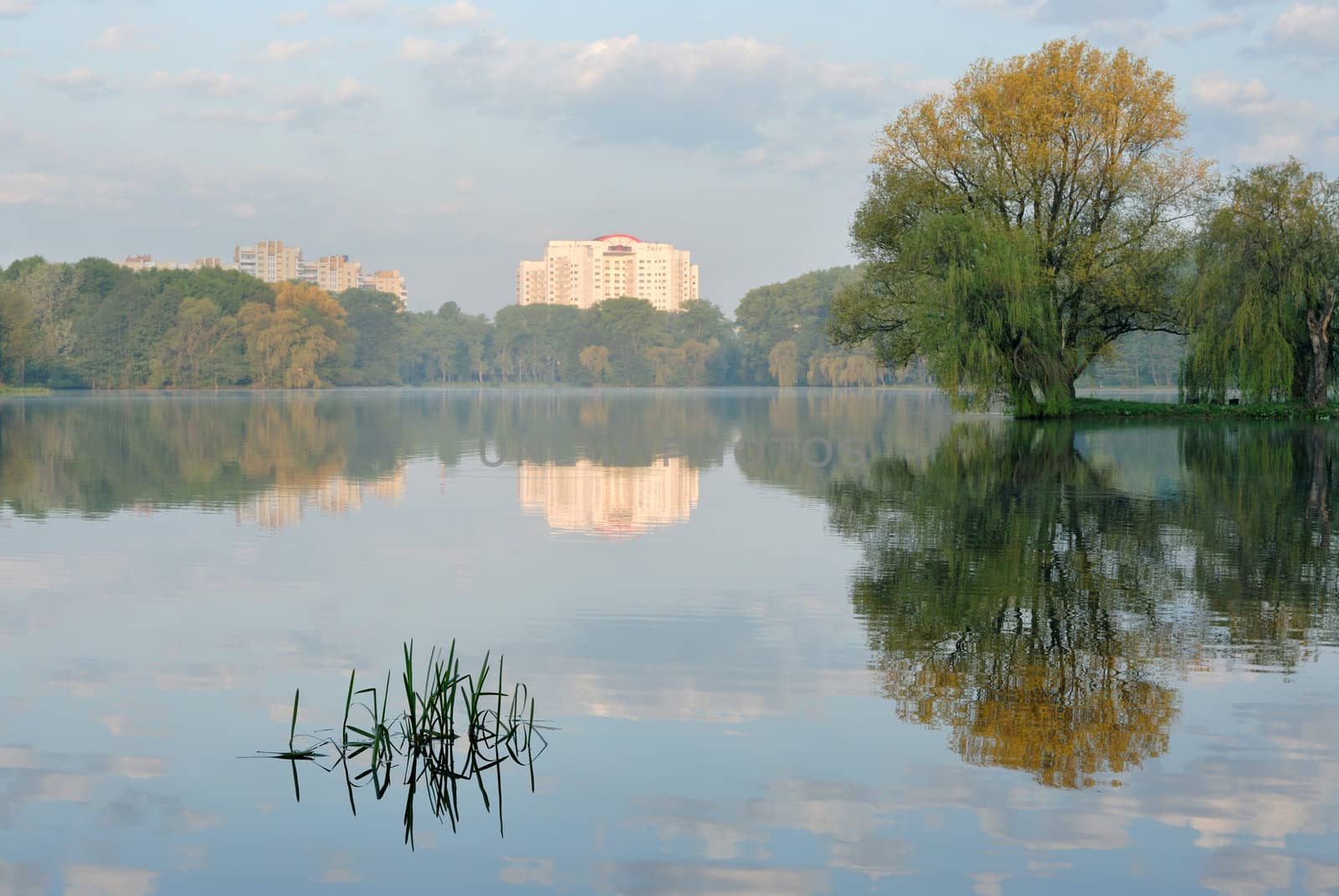Sunrise over lake in Minsk, the first beams of the sun.