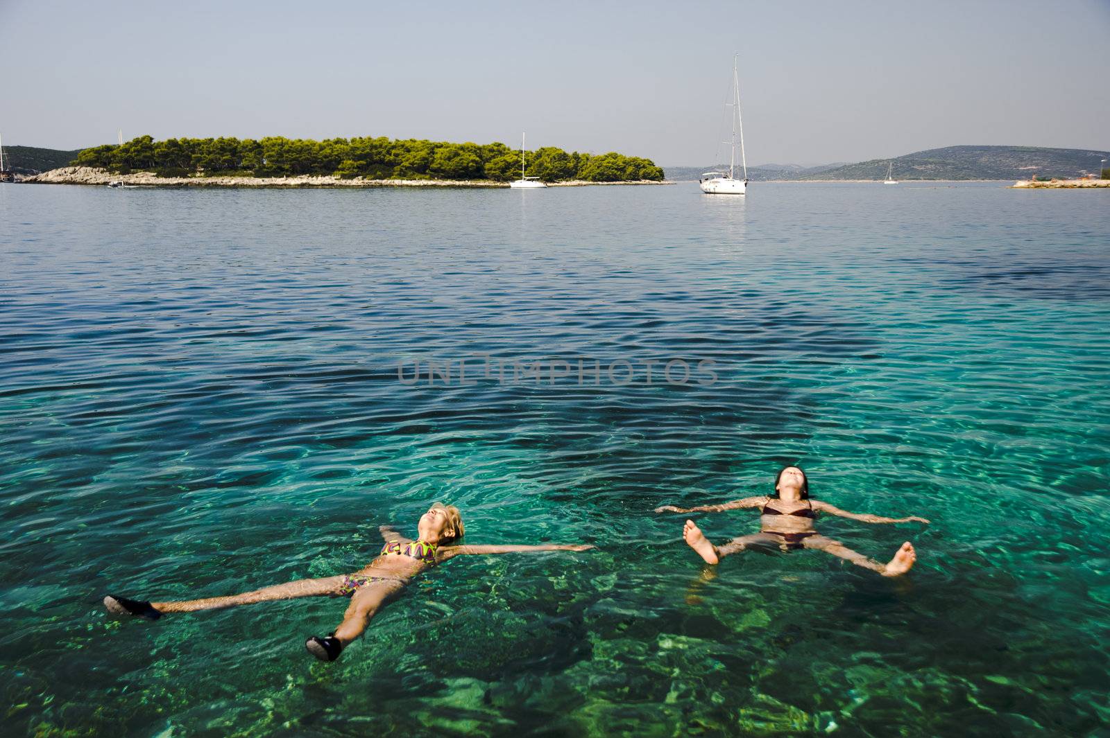 Two women relaxing on the Adriatic sea, Croatia.