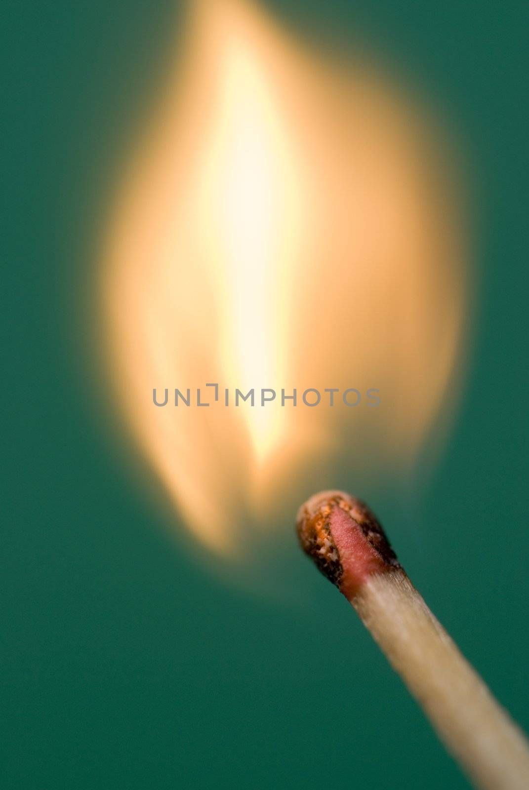 flames bursting from a matchhead just after lighting