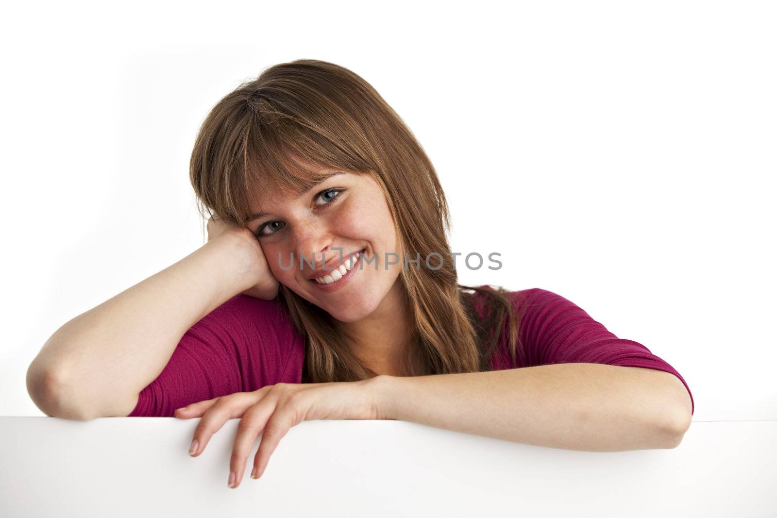 friendly young brunette woman leaning on a sign