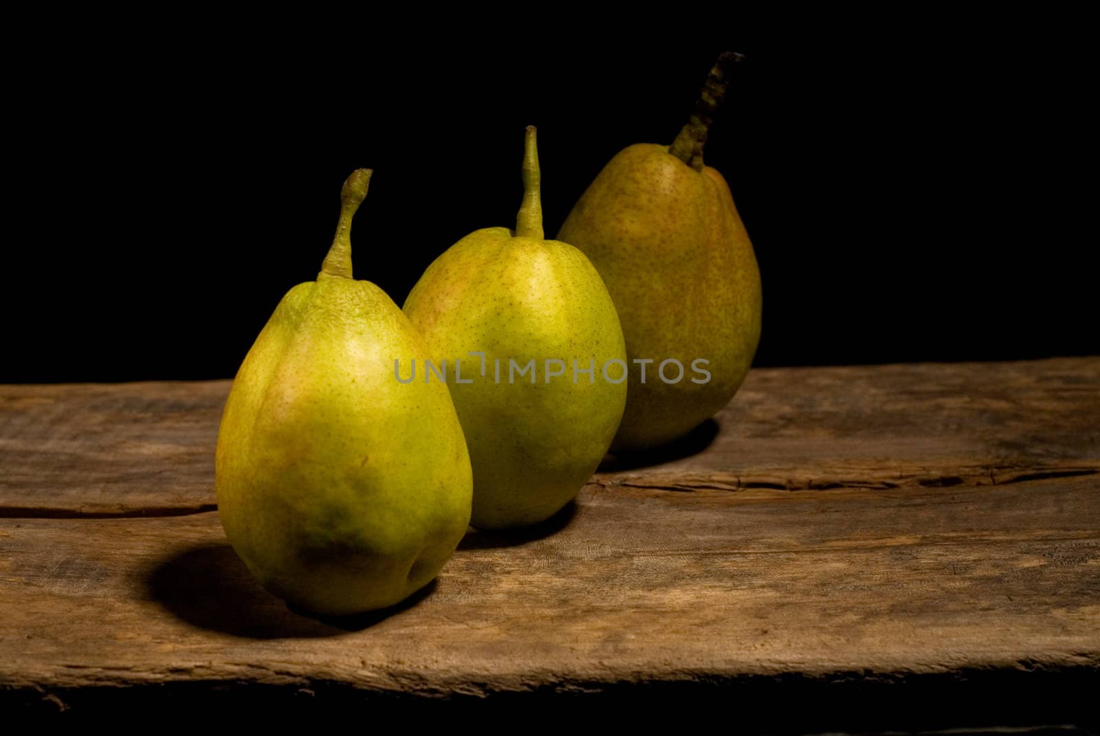 autumn fresh pears over old wood board 