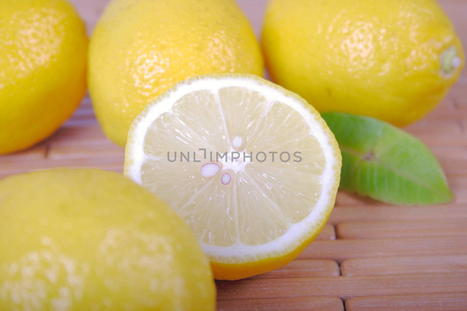 Lemons lying on a wooden napkin removed close up