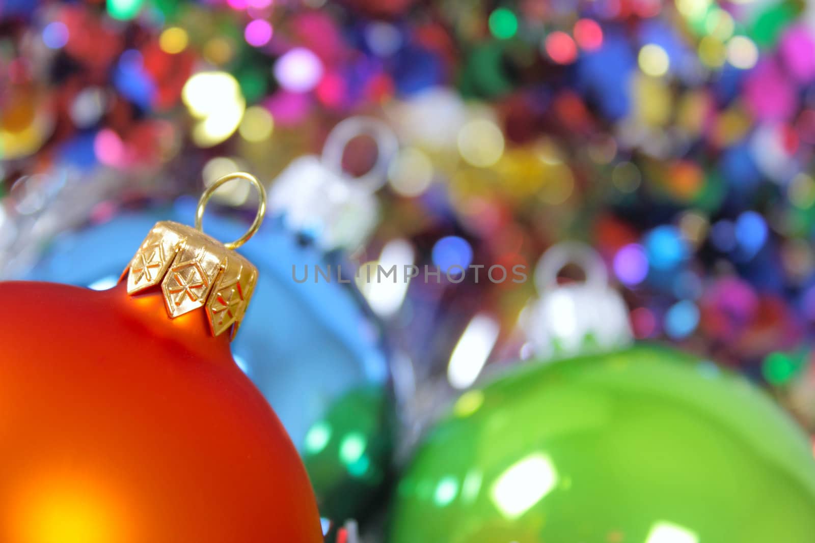 New Year's fur-tree toys against a multi-coloured tinsel removed close up