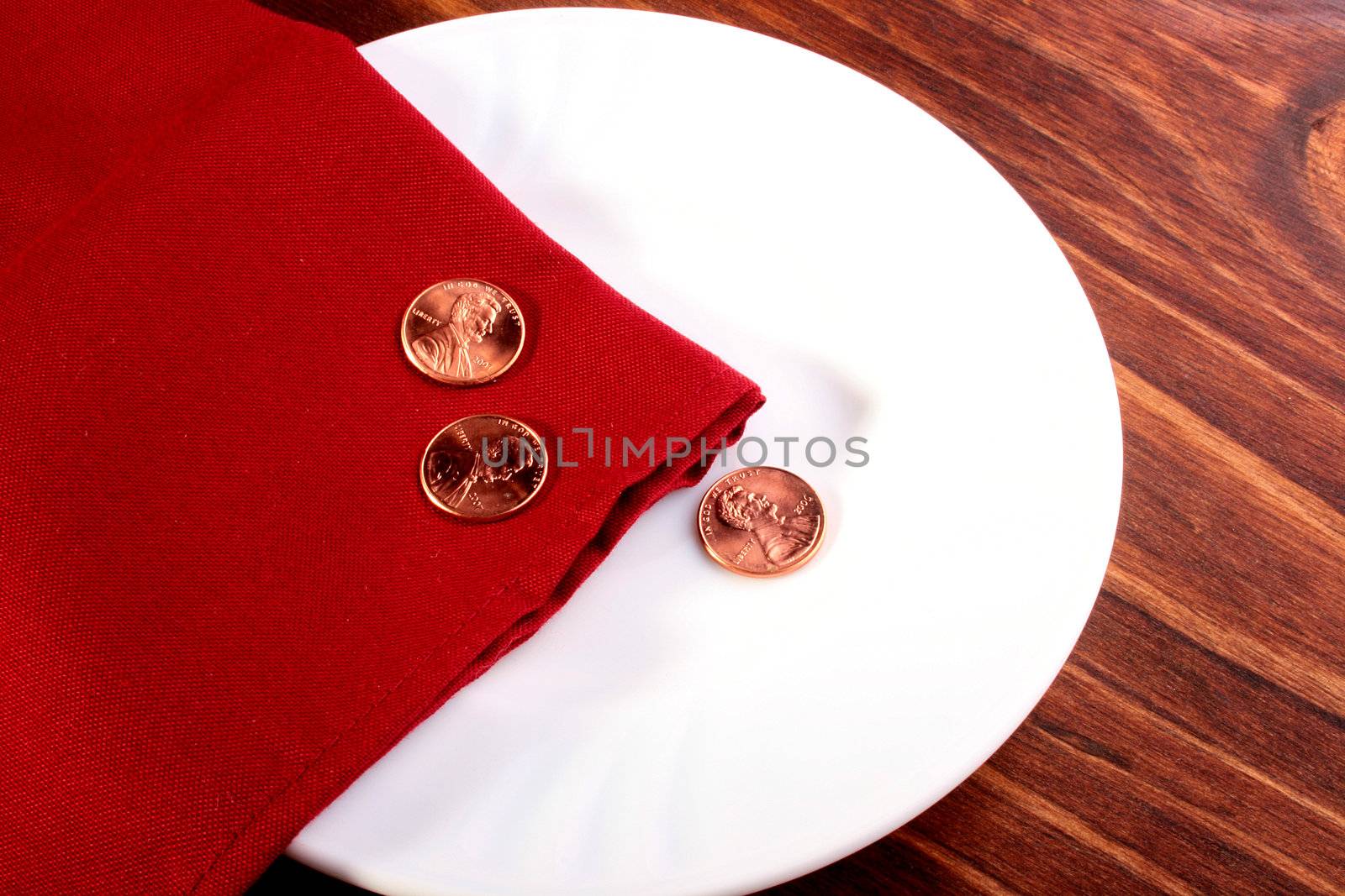 Three cents on a white plate with a red napkin.