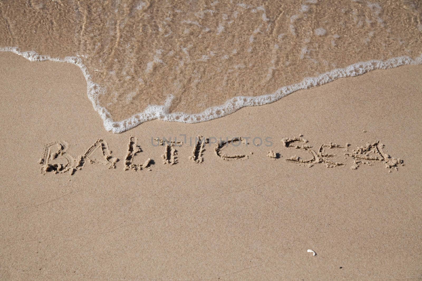 Baltic sea inscription on the coast of sea