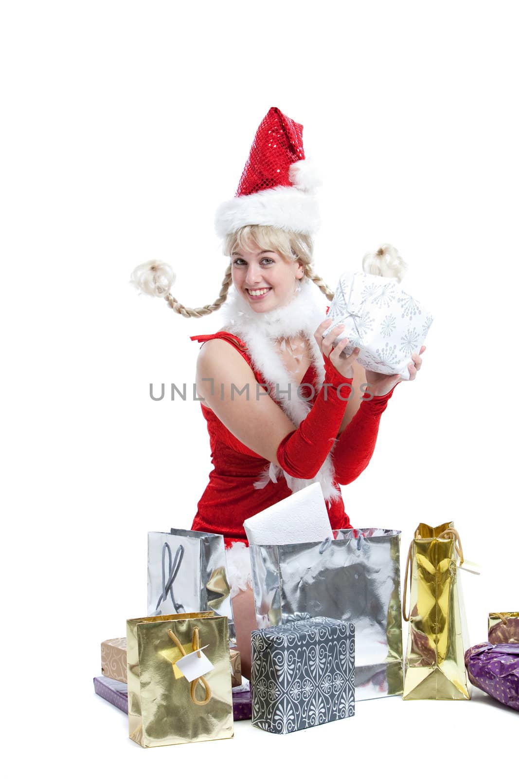 Cute young girl in christmas outfit with a lot of presents