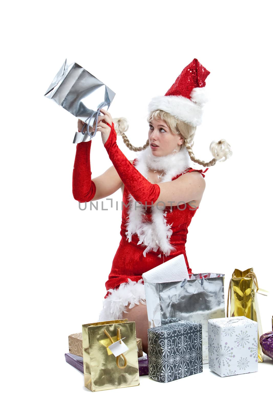 Cute girl looking at an empty package in christmas dress