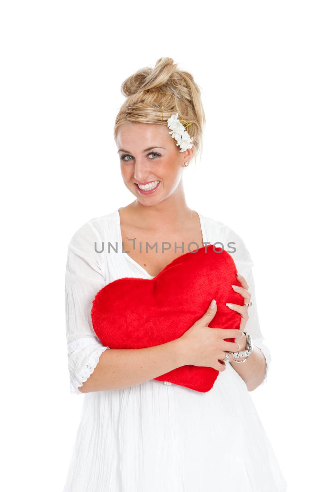 Pretty girl with big smile holding a red valentine heart