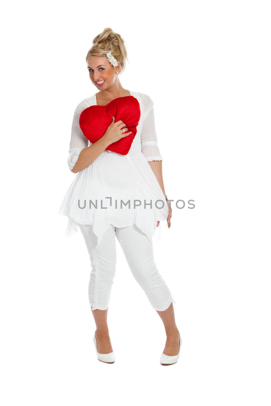 Pretty blond girl with big red valentine heart against her chest