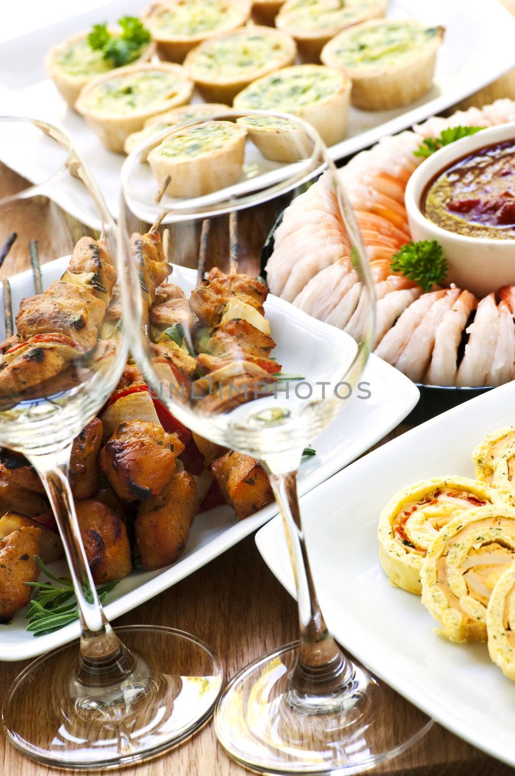 Many dishes of bite size appetizers and party food