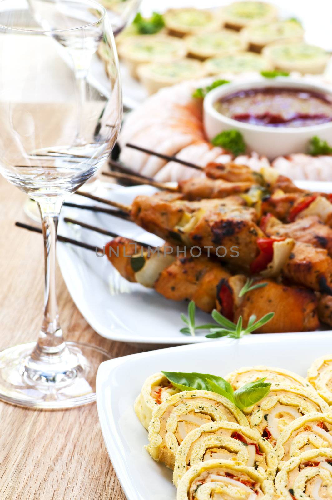 Many dishes of bite size appetizers and party food