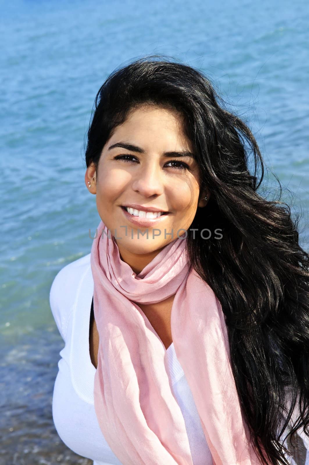 Portrait of beautiful smiling brunette girl at beach