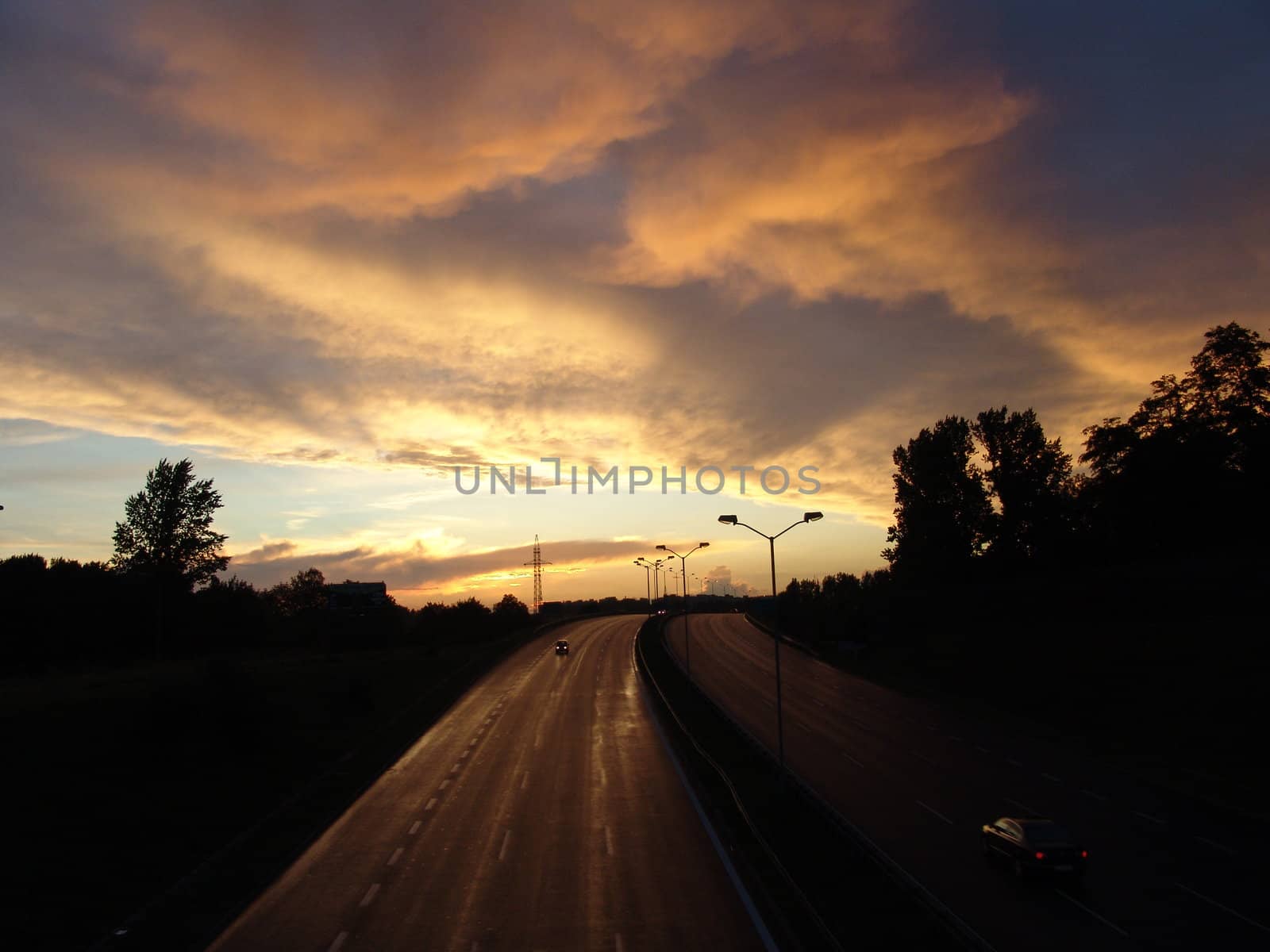 Sunset on the highway. Beautiful, scenic clouds.