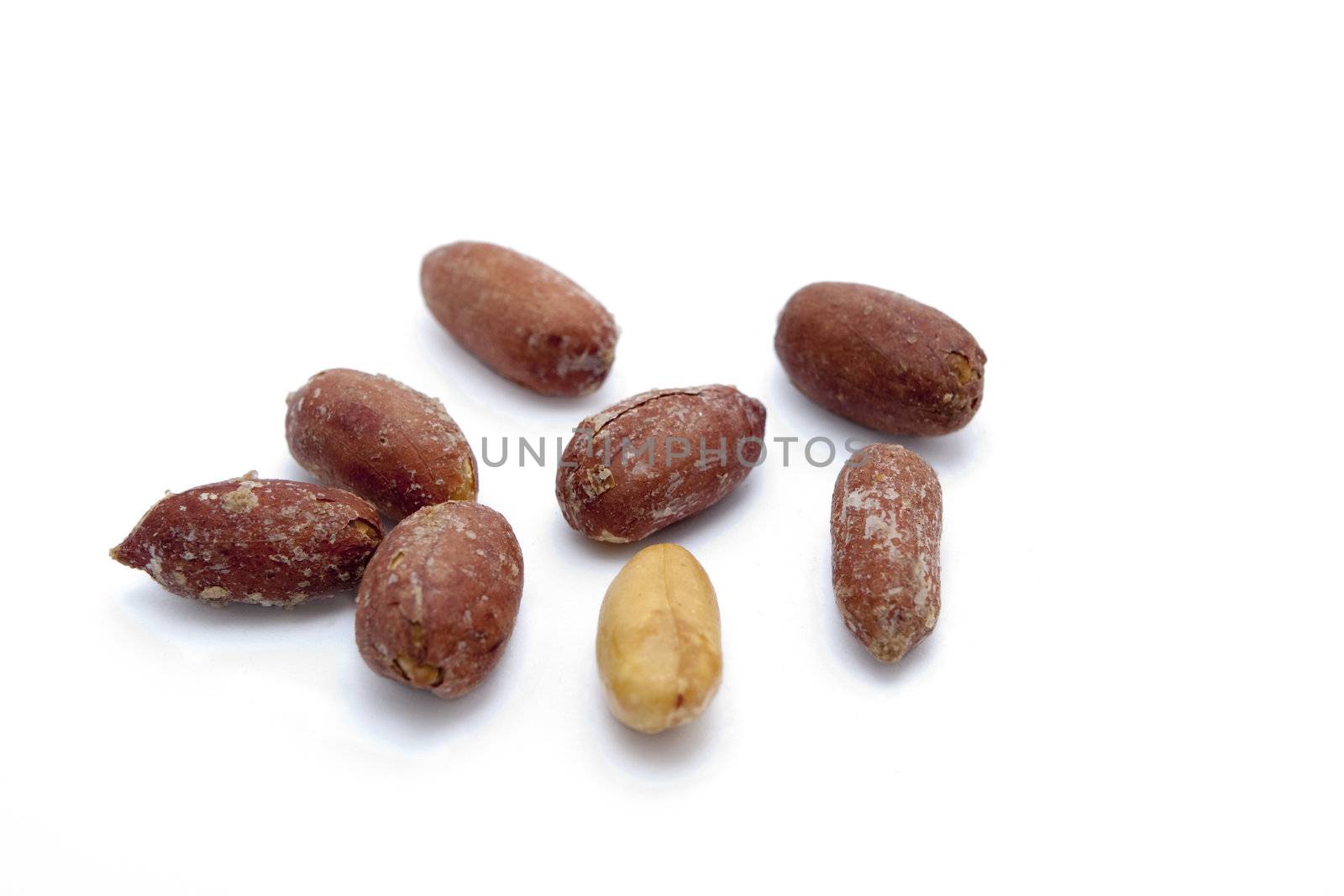 	
salted peeled peanuts on a white background