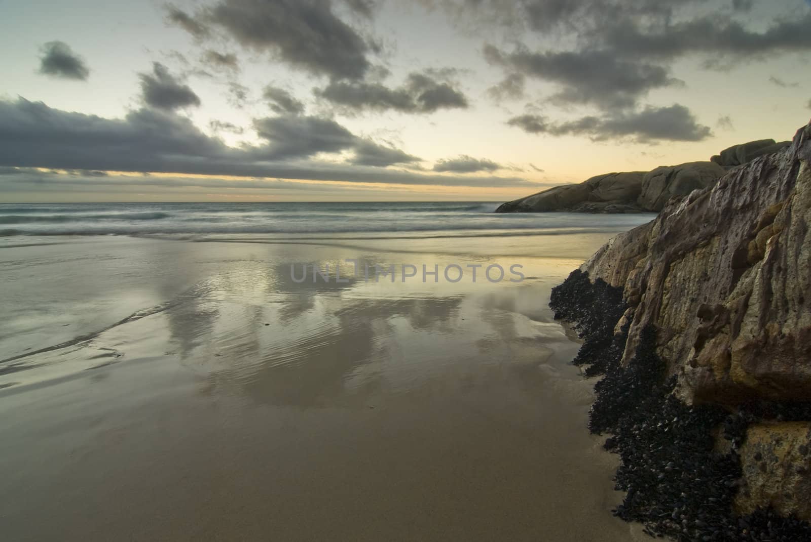 Rocky beach with sunset in the background