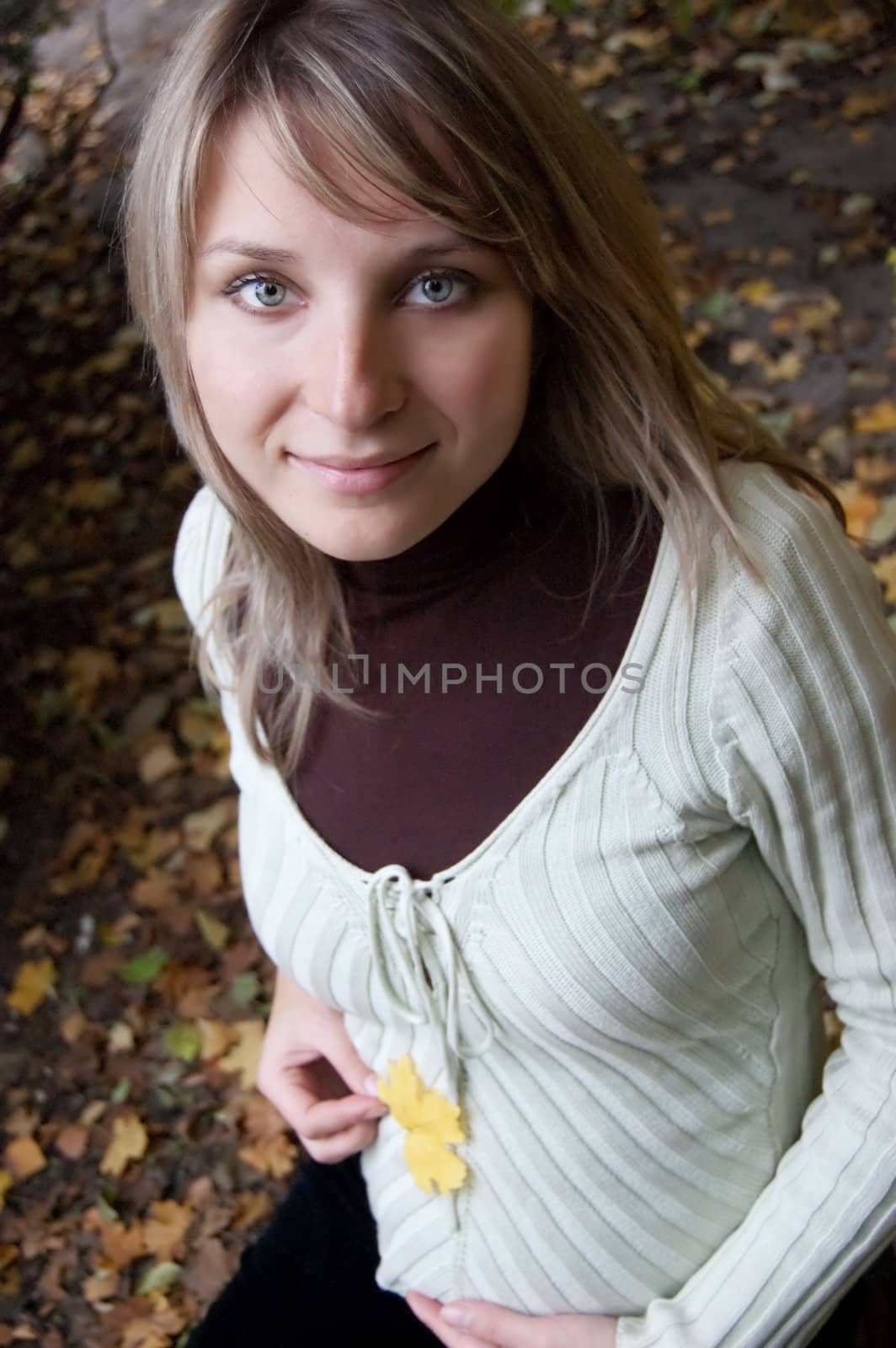 Pretty pregnant woman over autumn background