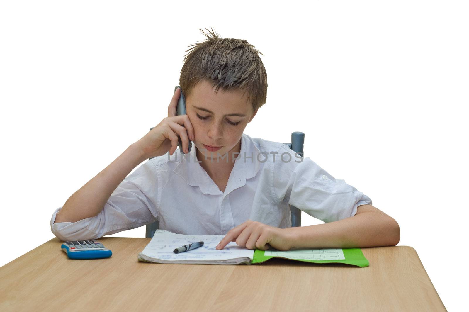 a teen boy studying and getting help from someone on the phone.