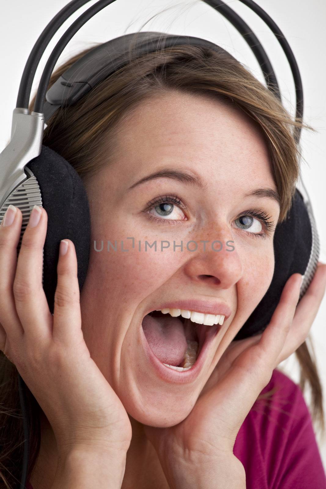 young woman screams for joy while listening to music