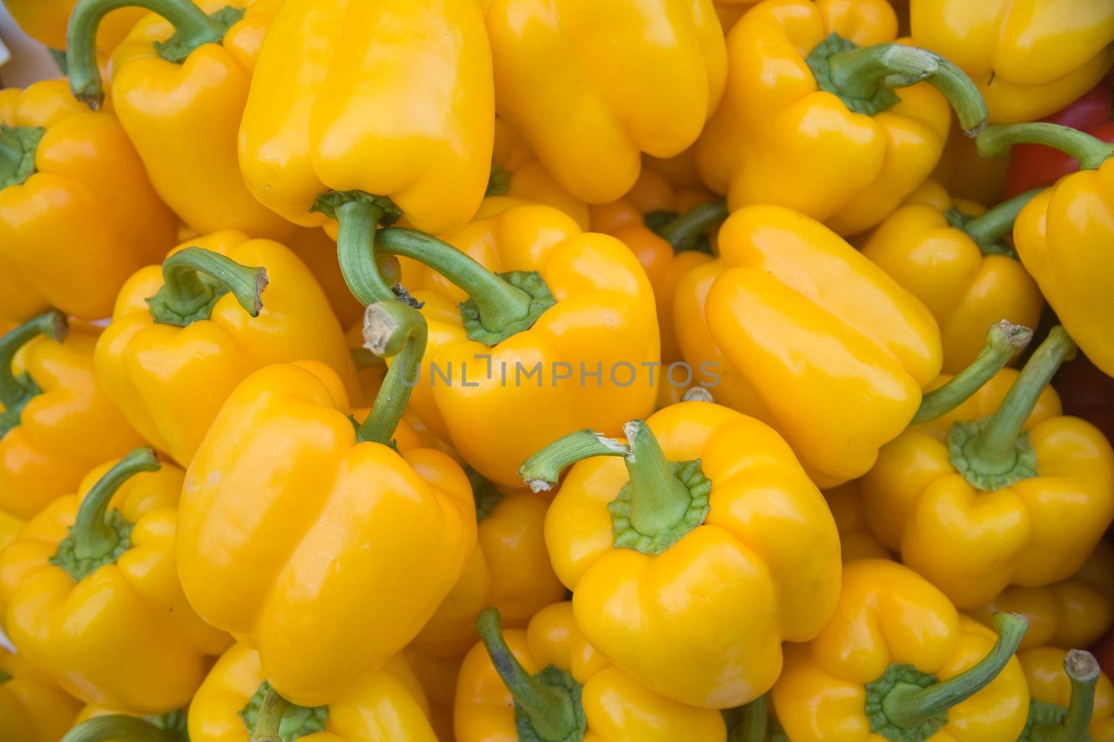 Yellow pepper vegetables on a market stall.