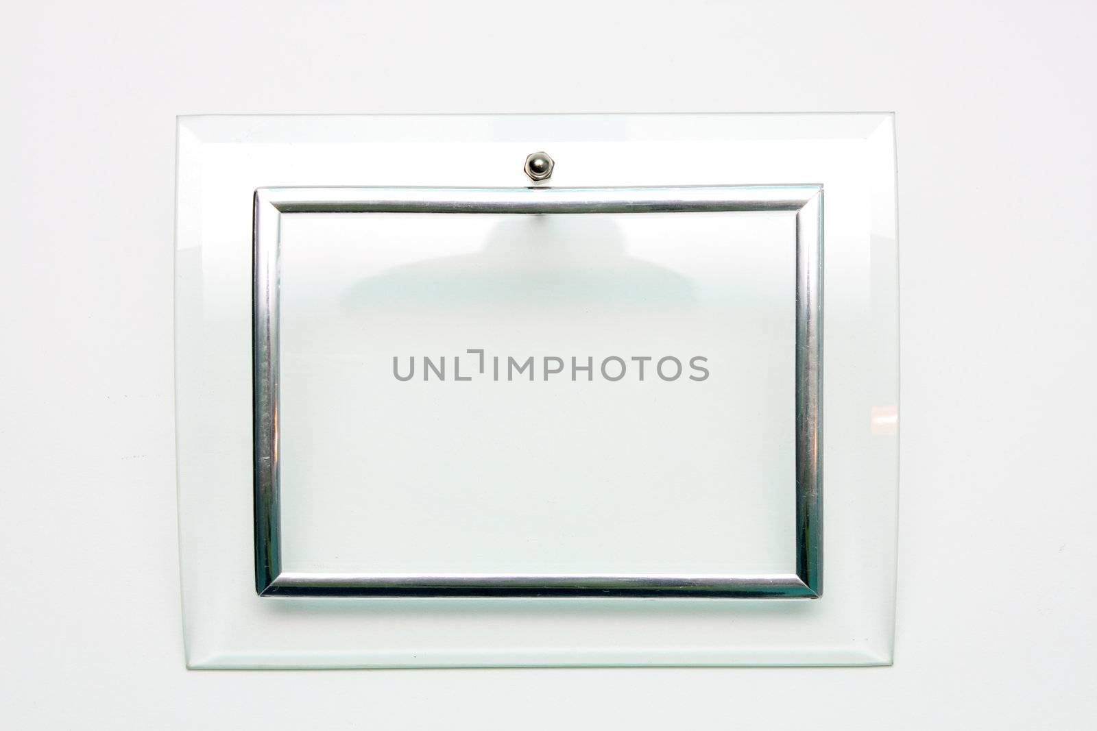 An empty picture frame, metal and glass on a white background