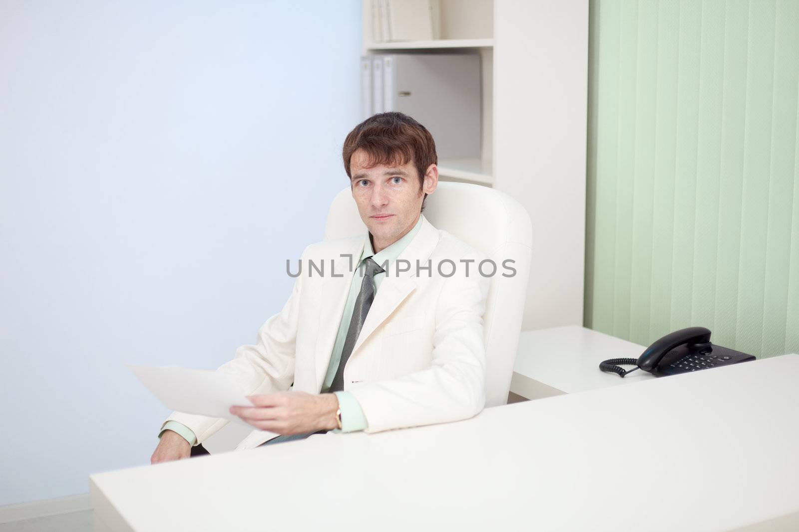 The person sits at office on a workplace