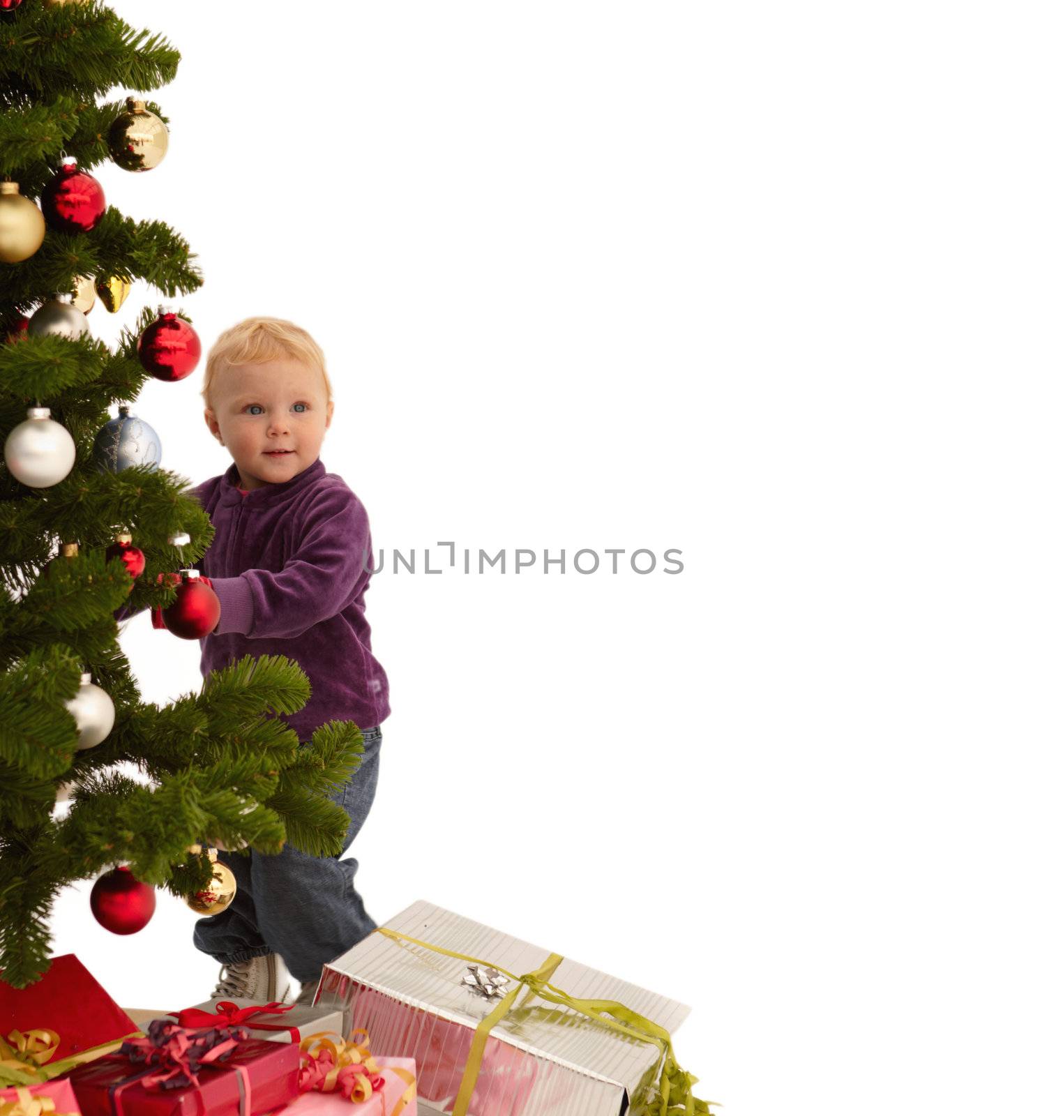 Christmas - Child putting decorations on x-mas tree