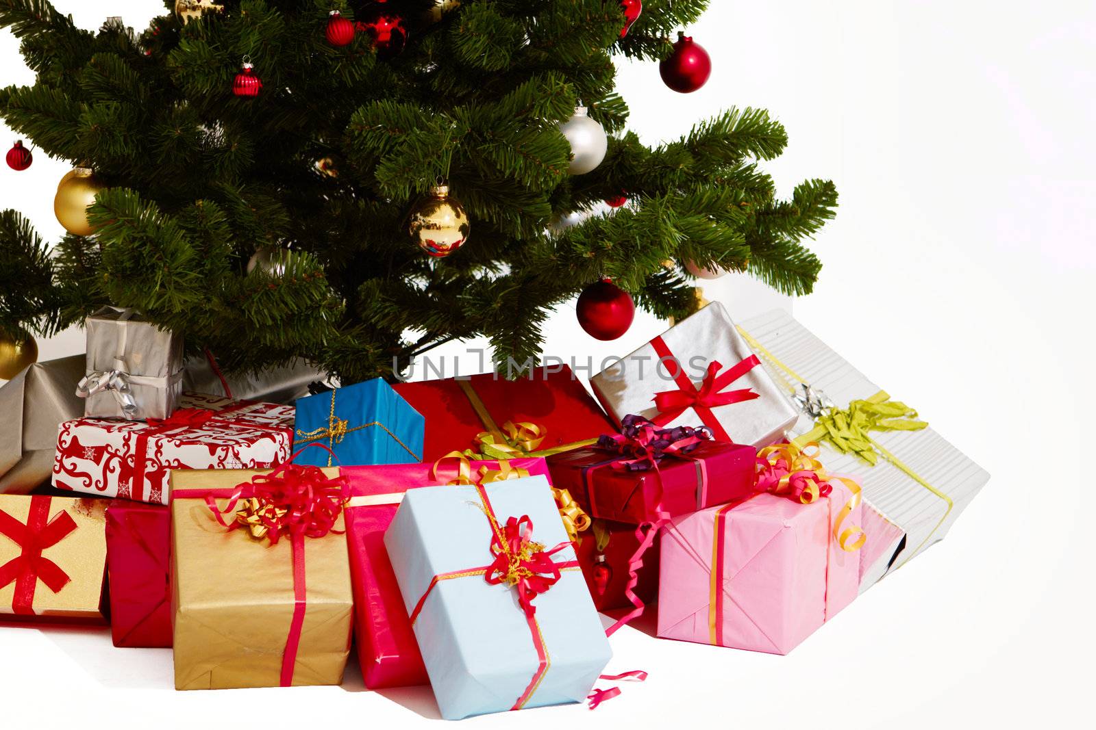 Christmas - Presents under a tree on white by FreedomImage