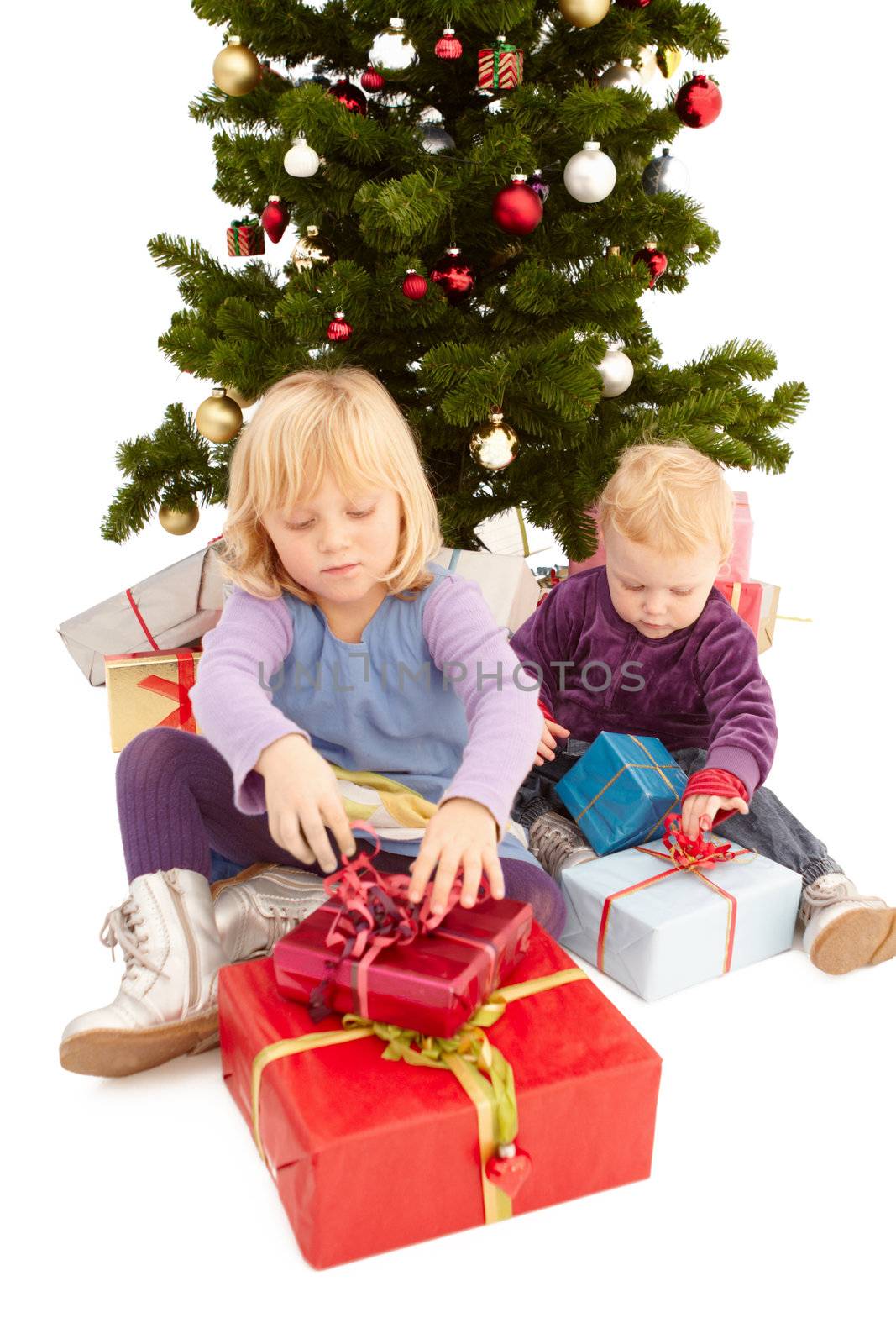 Christmas - Cute young girls opening their presents by FreedomImage