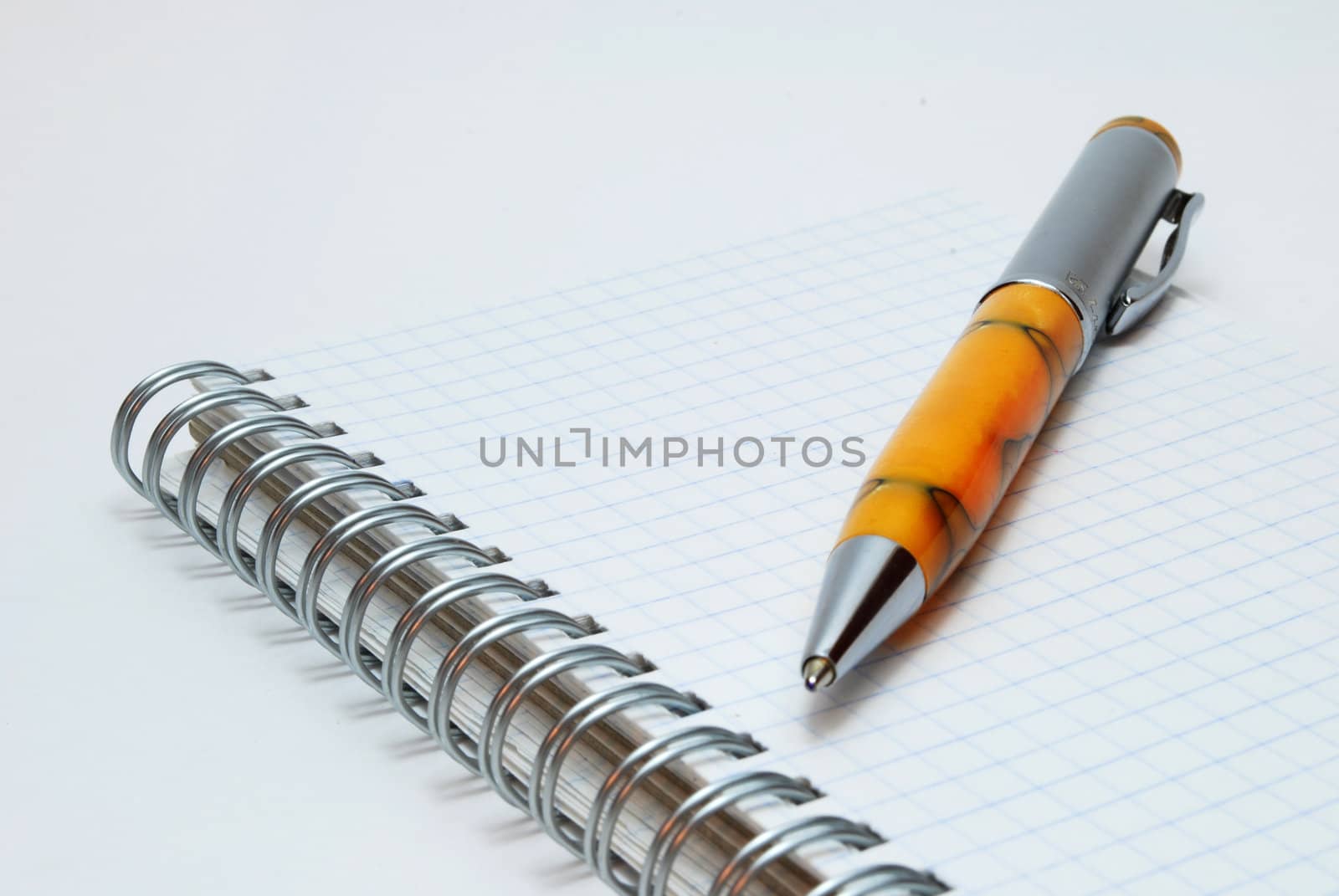 Ballpoint Pen on Notebook Isolated on White