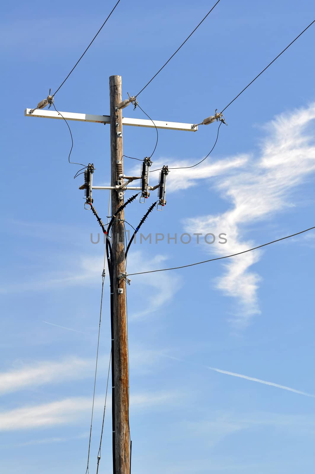 Electrical power pole with associated distribution lines and components.