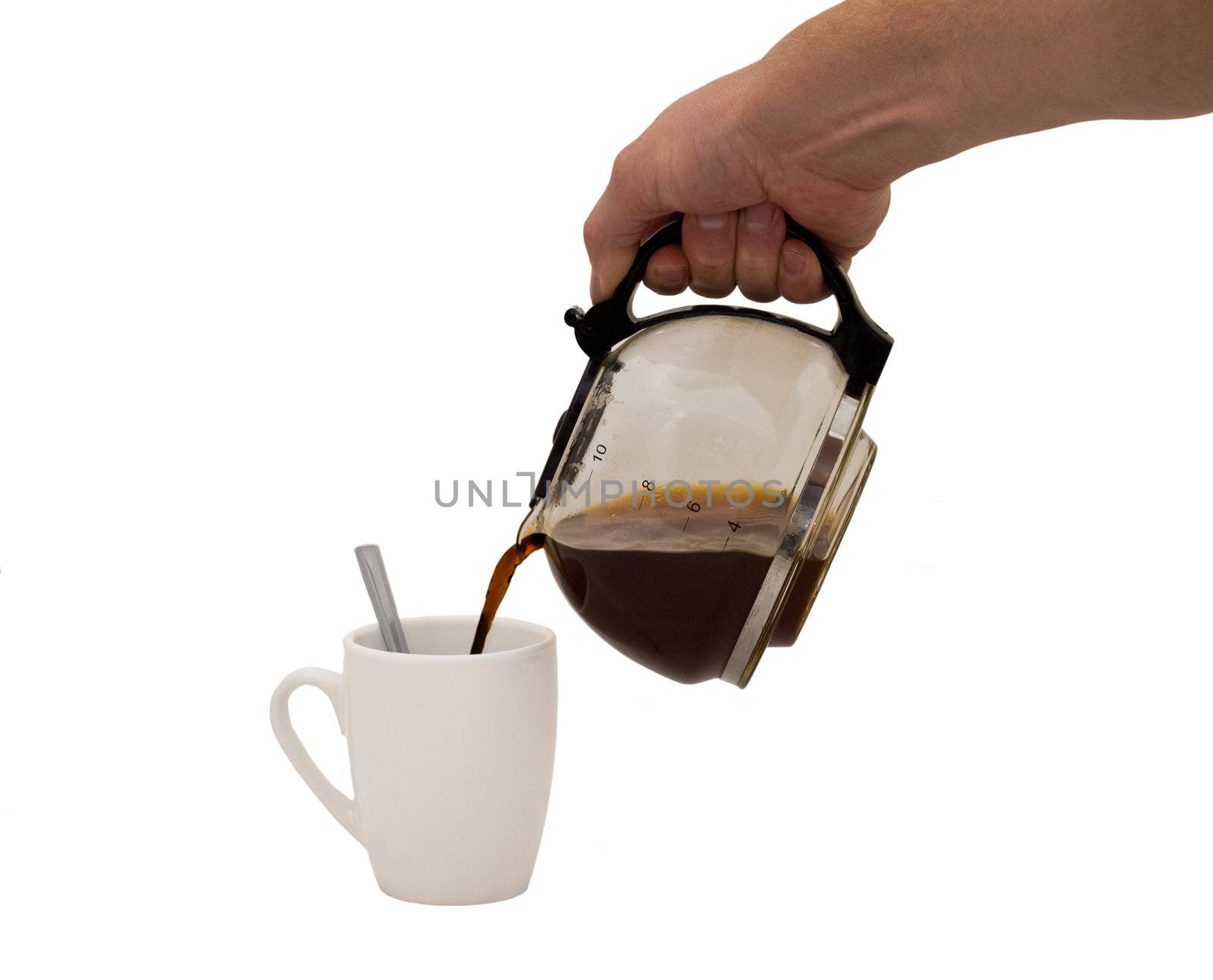 an isolated over white image of a caucasian man's hand holding and pouring coffee into a white mug complete with spoon.