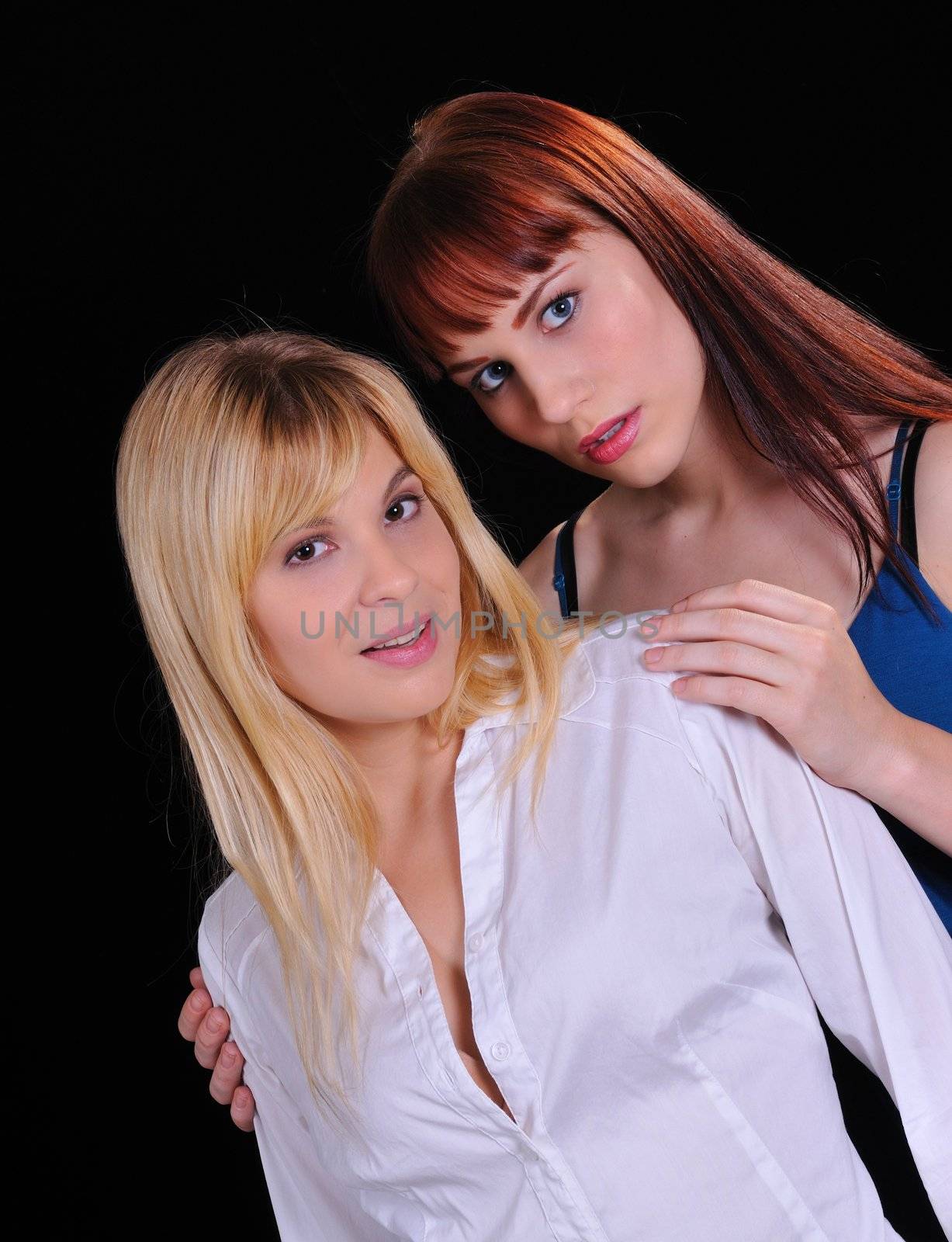 Two attractive models posing on a black background