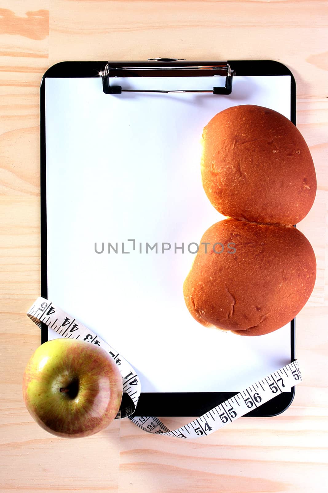 Apple and roll on Blank Clipboard with tape-measure for those who is or going to be engaged in diet.