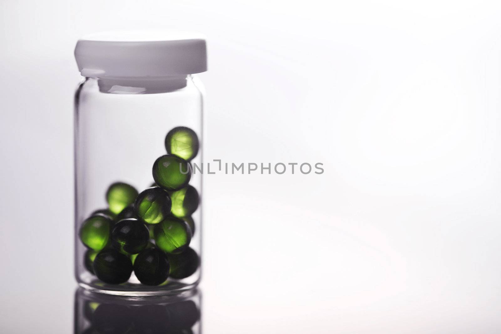 green gel capsules isolated on white background