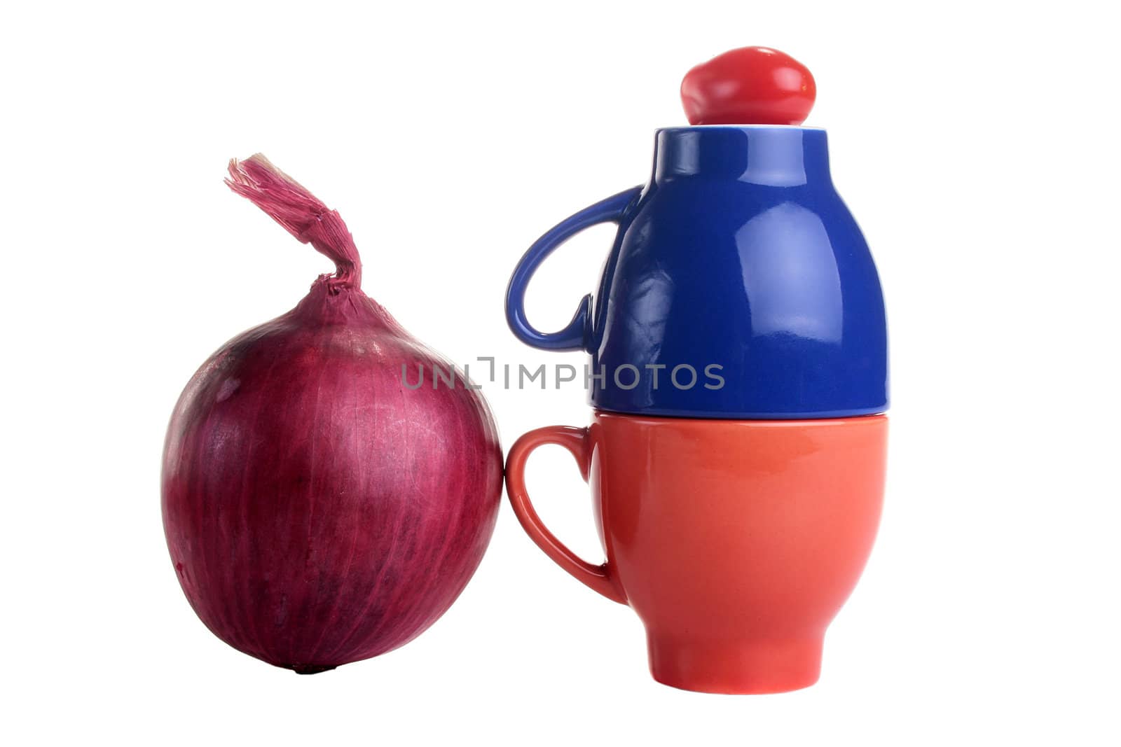 Two cups with a tomato from above and a red onion.