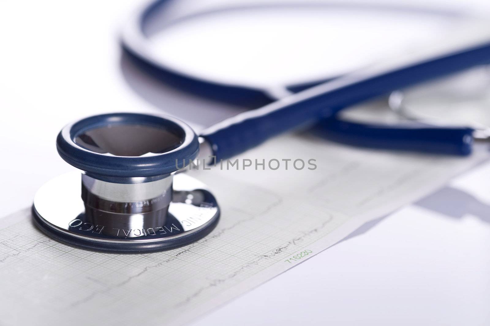 stethoscope and ekg isolated on white background, close up