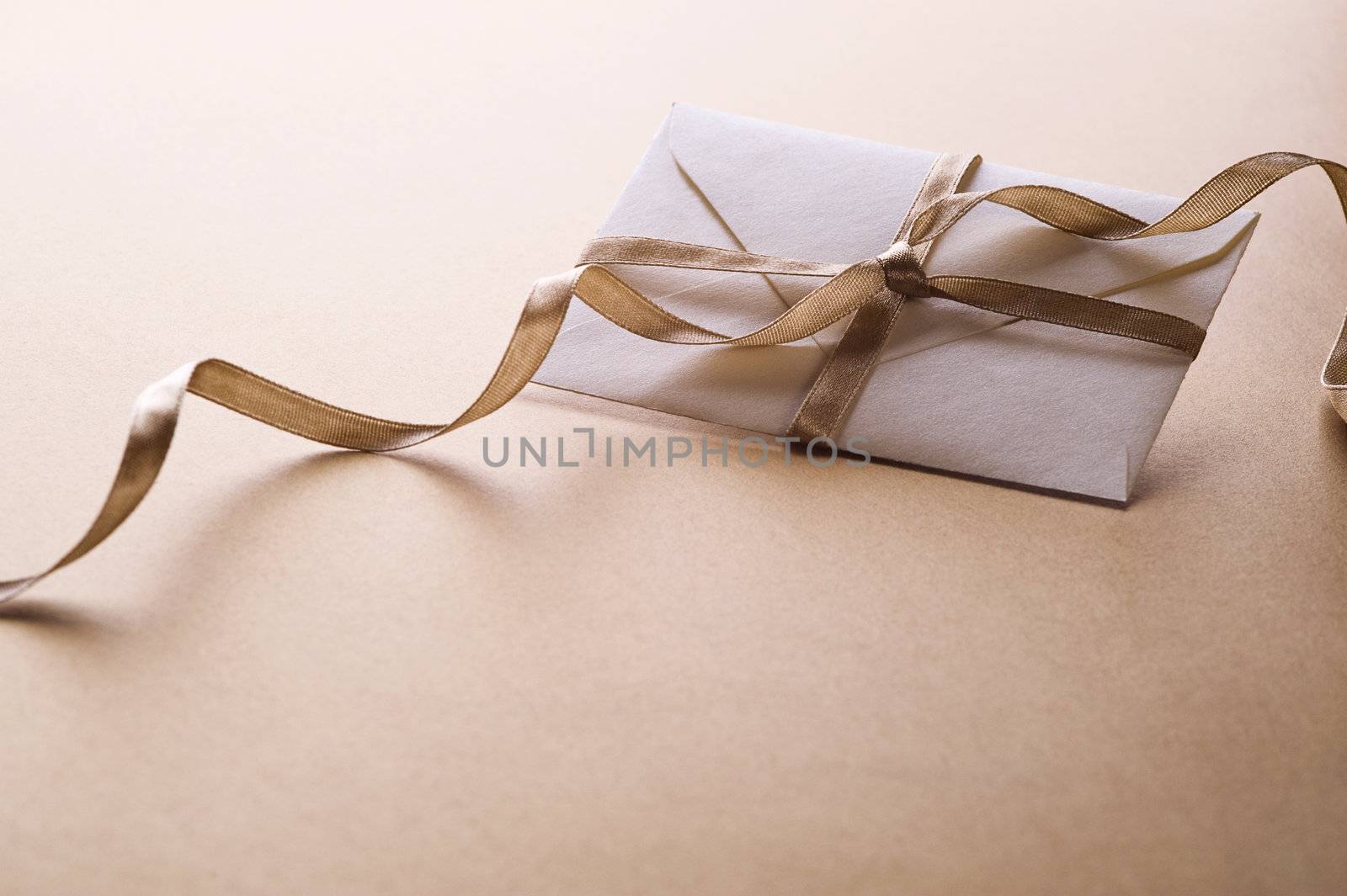 envelope with decorative ribbon on gold background