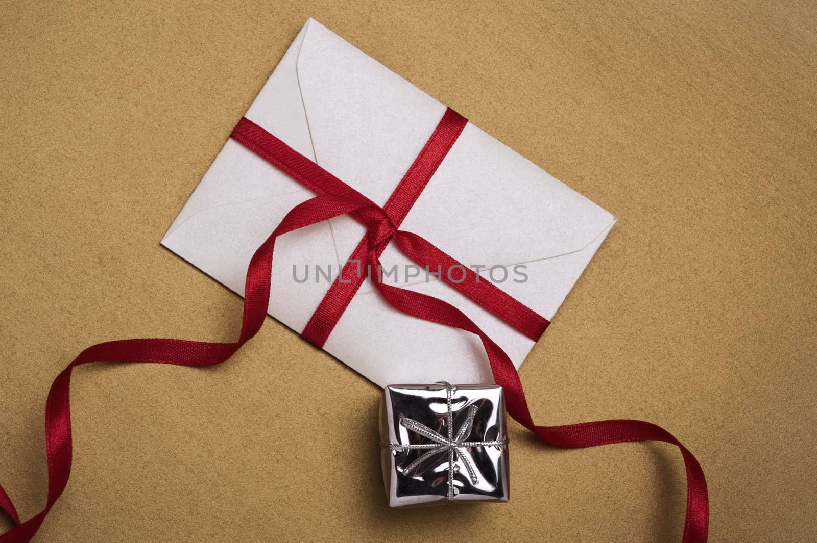 christmas envelope with red ribbon and small gift