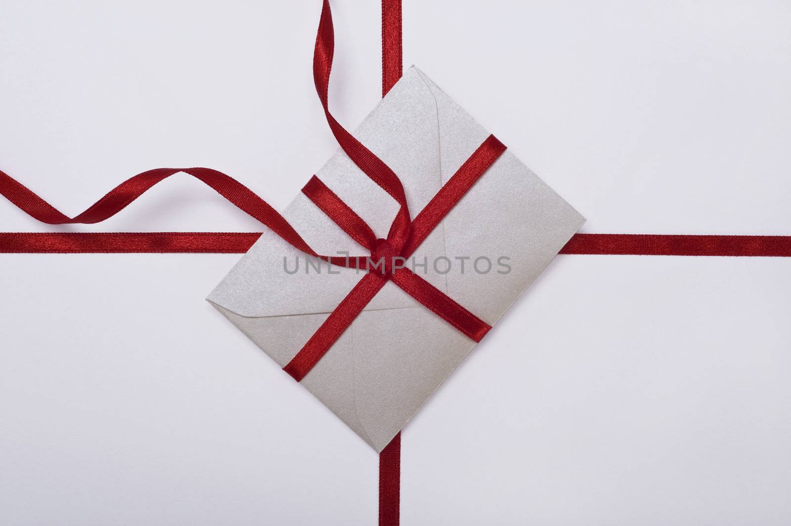 christmas envelope with red ribbon on white background