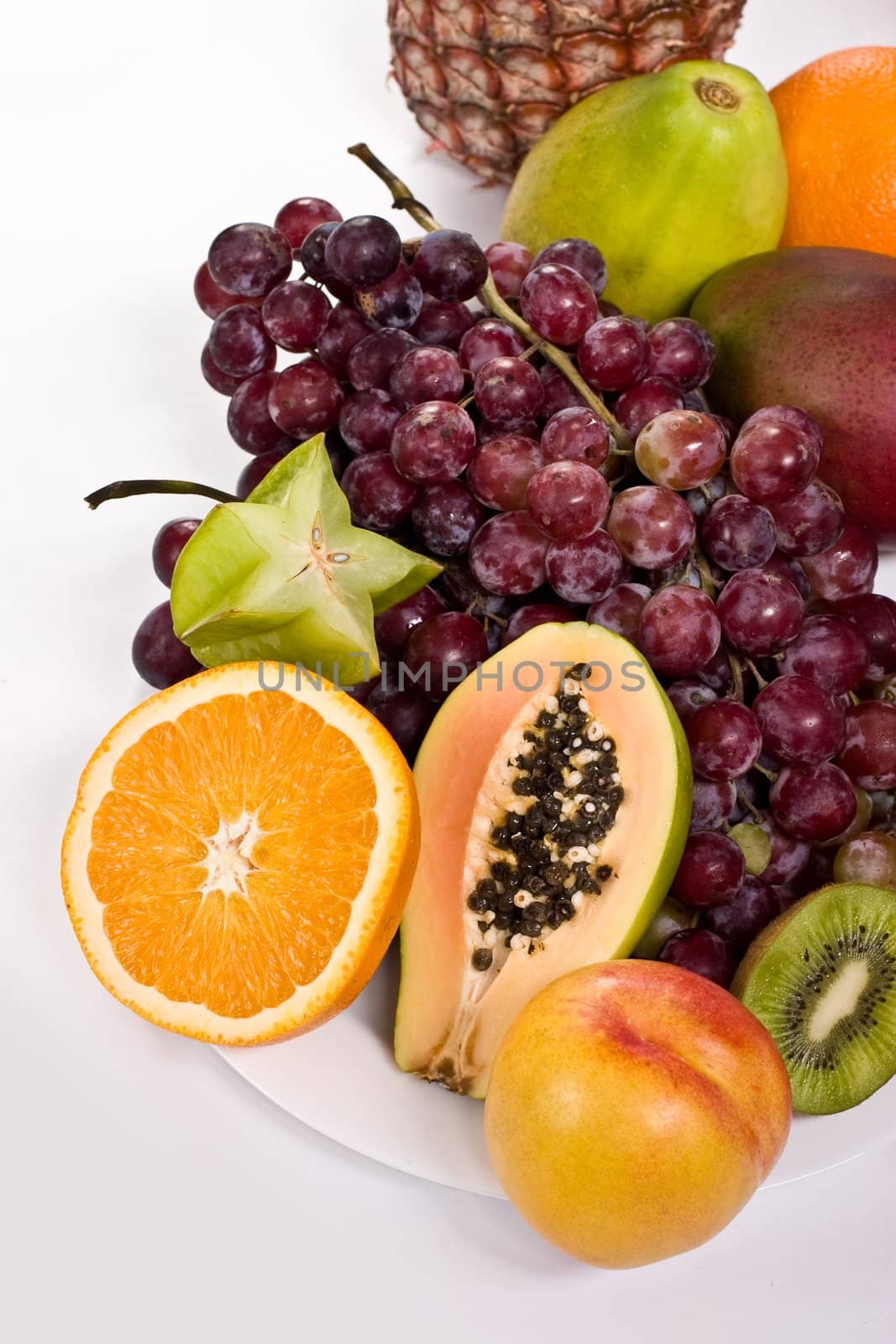 Healthy fruit assortment with papaya, kiwi, orange and grapes