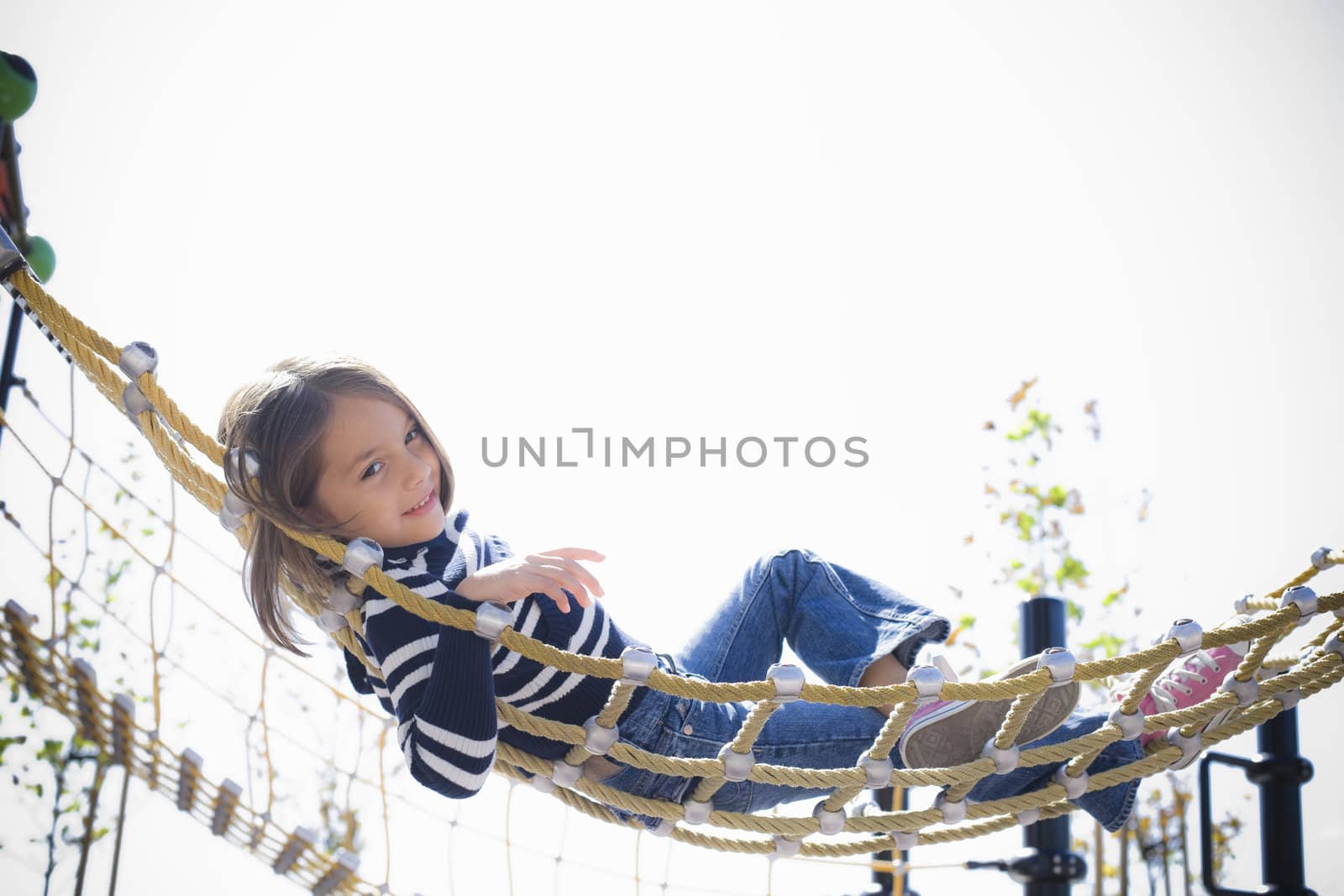 Young Girl Lying on Hammock Smiling To Camera