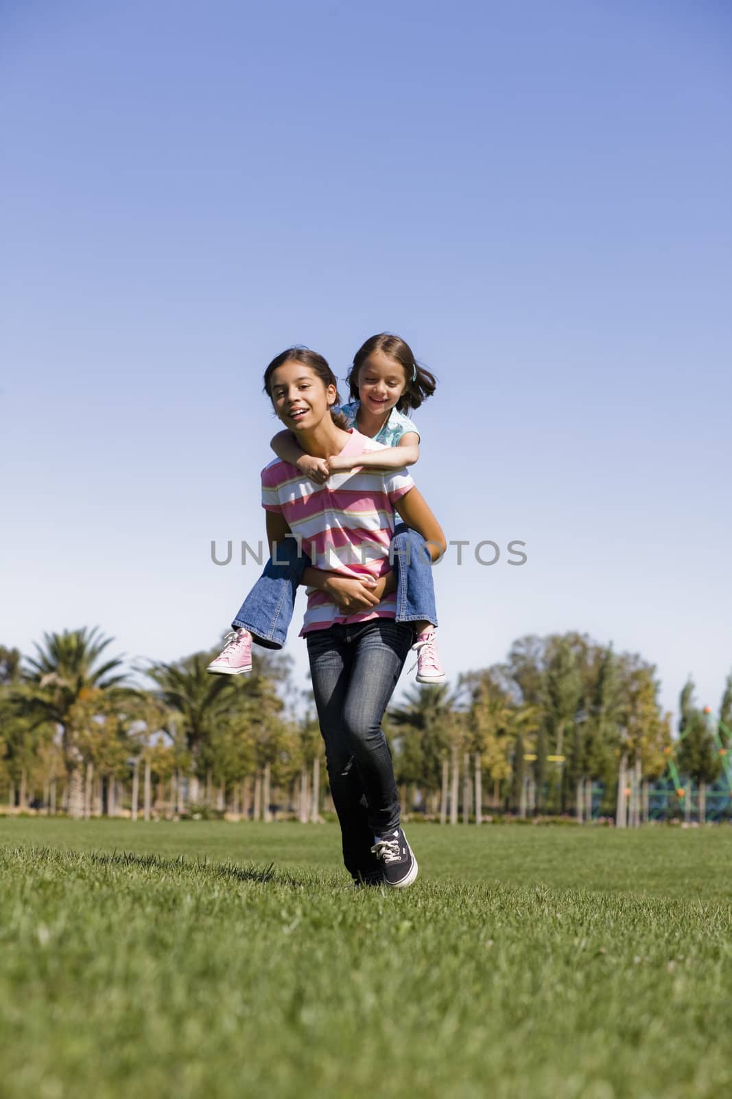 Two Sisters in Park by ptimages