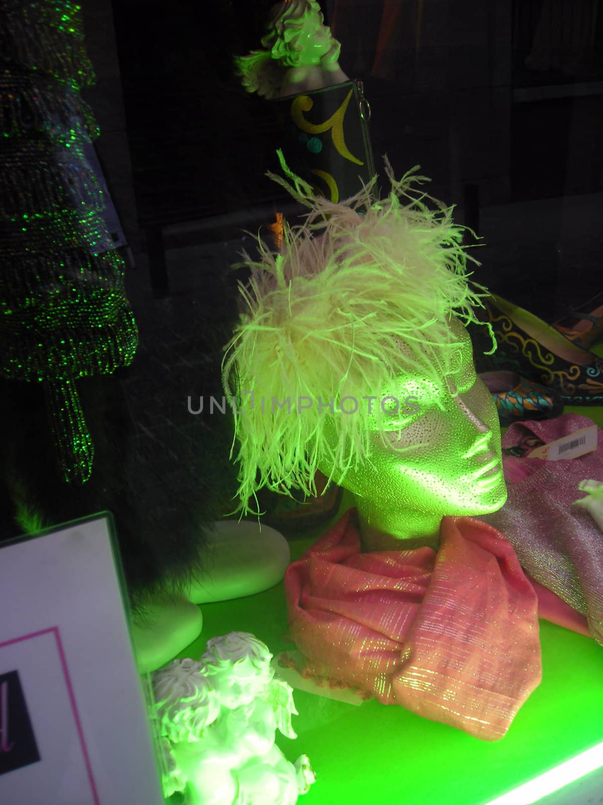 View of a green dummy in a shop window.